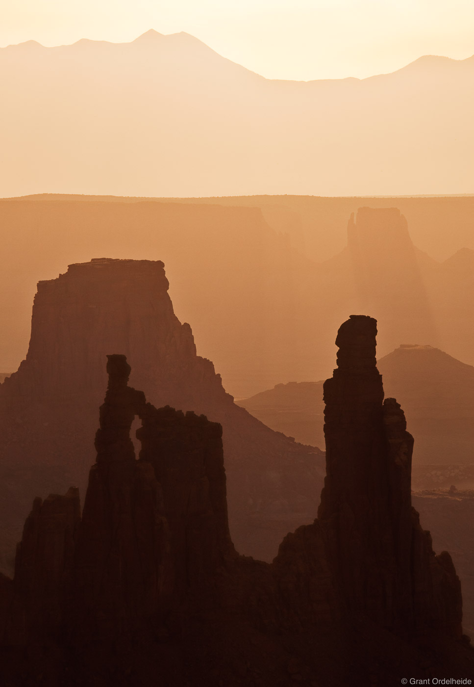 A hazy morning over Washer Woman Arch, Monster Tower, and Airport Tower in Canyonlands National Park.