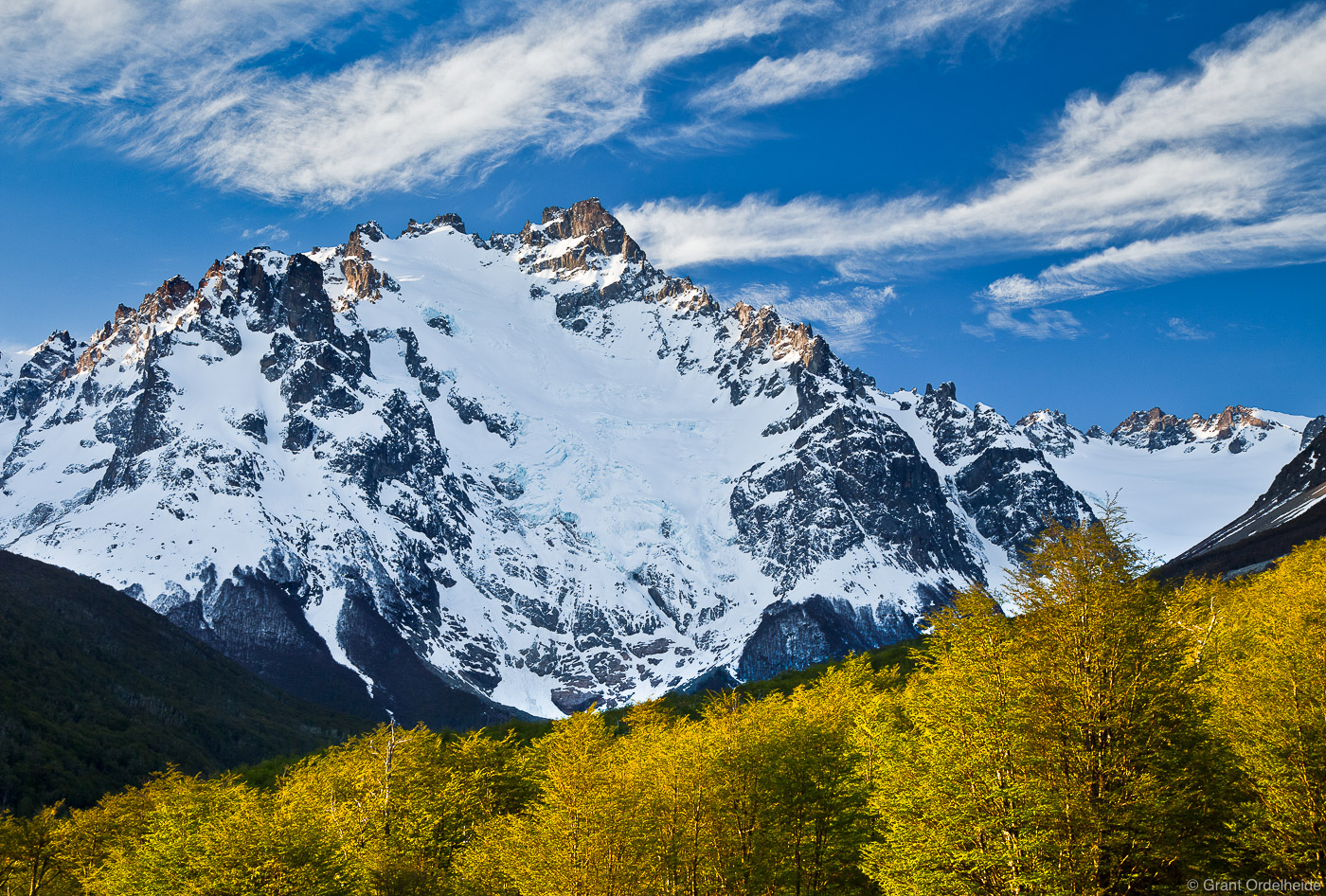 Cerro Peñon, the second tallest peak in the Cerro Castillo National reserve, stands tall above spring lenga trees.