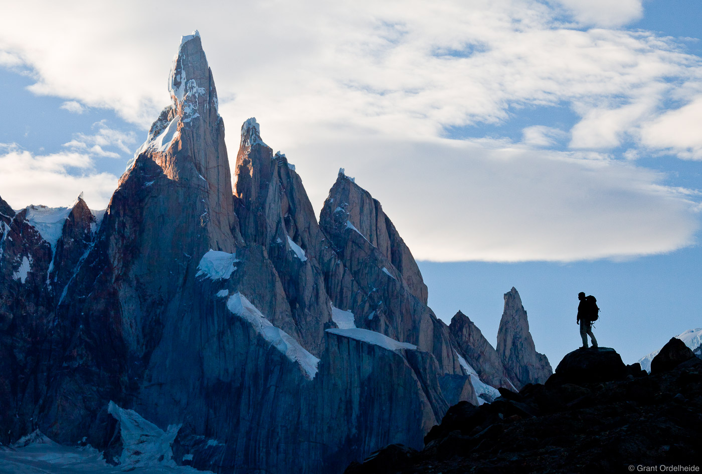 A hiker below the enormous&nbsp;Cerro Torre.