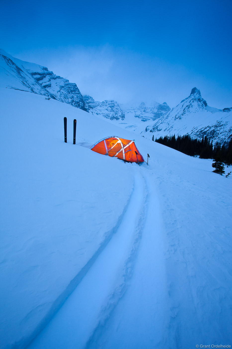 Skis and illuminated tent in the Canadian Rockies.