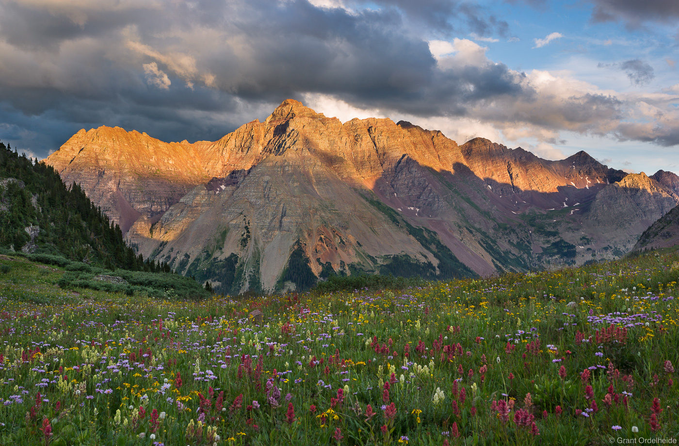 The 14,025 foot Pyramid Peak towers above the wildflower carpets below Buckskin Pass along the popular Four Pass Loop trail.