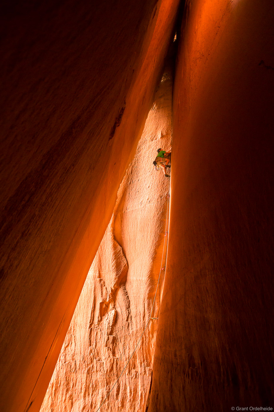 A climber scales the Cave Route (5.10d) on the Battle of the Bulge cliff in Indian Creek.