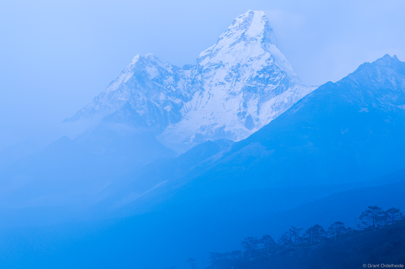 Ama Dablam rises from the fog as viewed from the village of Tengboche in the Everest Region of Nepal.