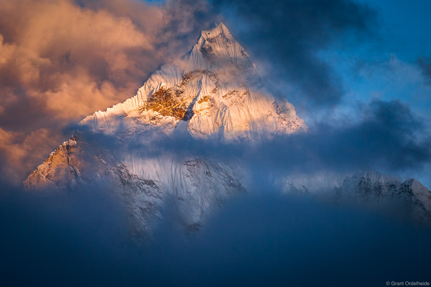 Ama Dablam peaks through the clouds in the Everest Region of Nepal's Himalaya.