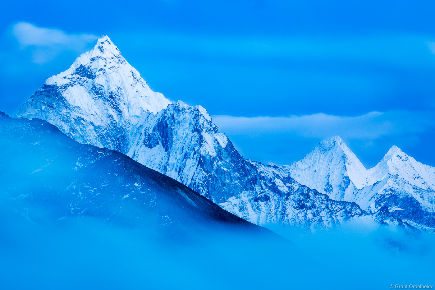 Fog creeps down the valley below Ama Dablam in the Everest Region in Nepal's Himalaya.