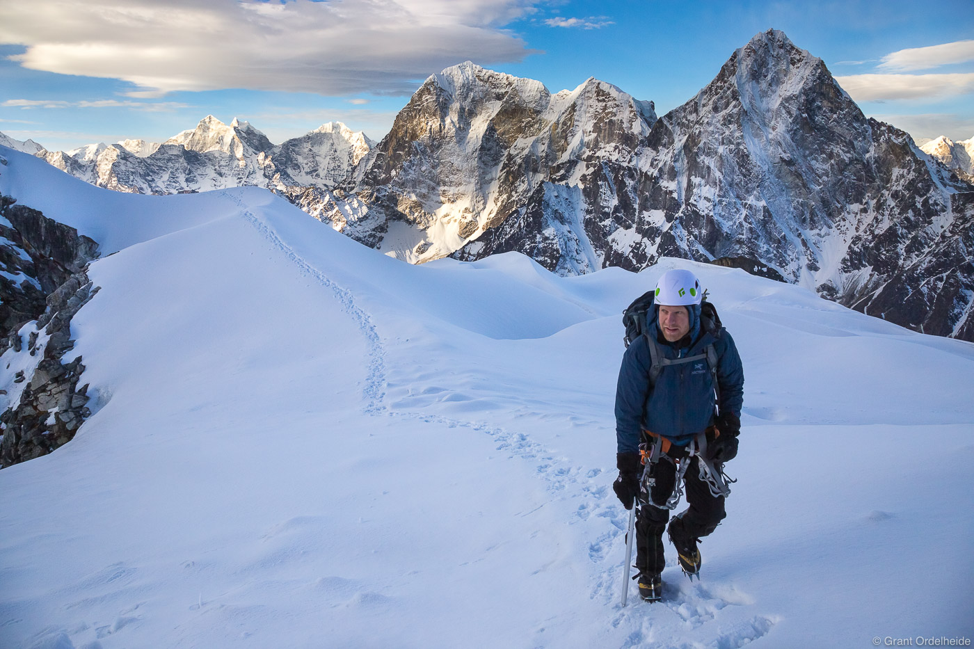 A climber  high on Lobuch East with Taboche and Cholatse in the background.