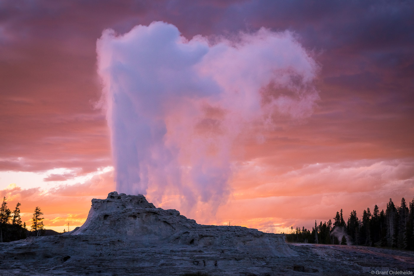 Sunset over the Castle Geyser in Yellowstone National Park.