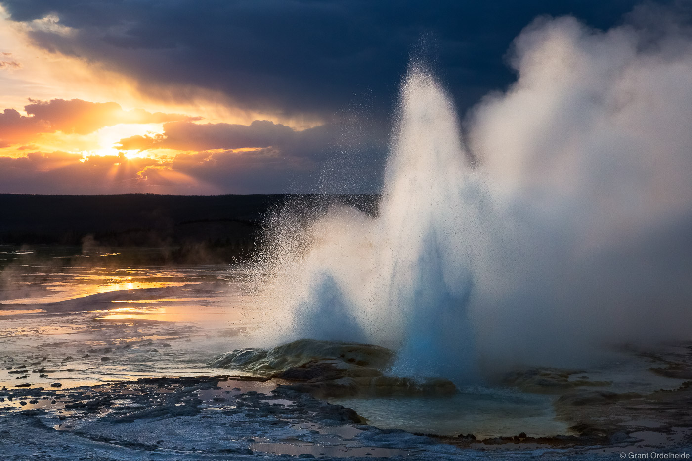 Sunset over the Clepsydra Geyser in Yellowstone National Park.