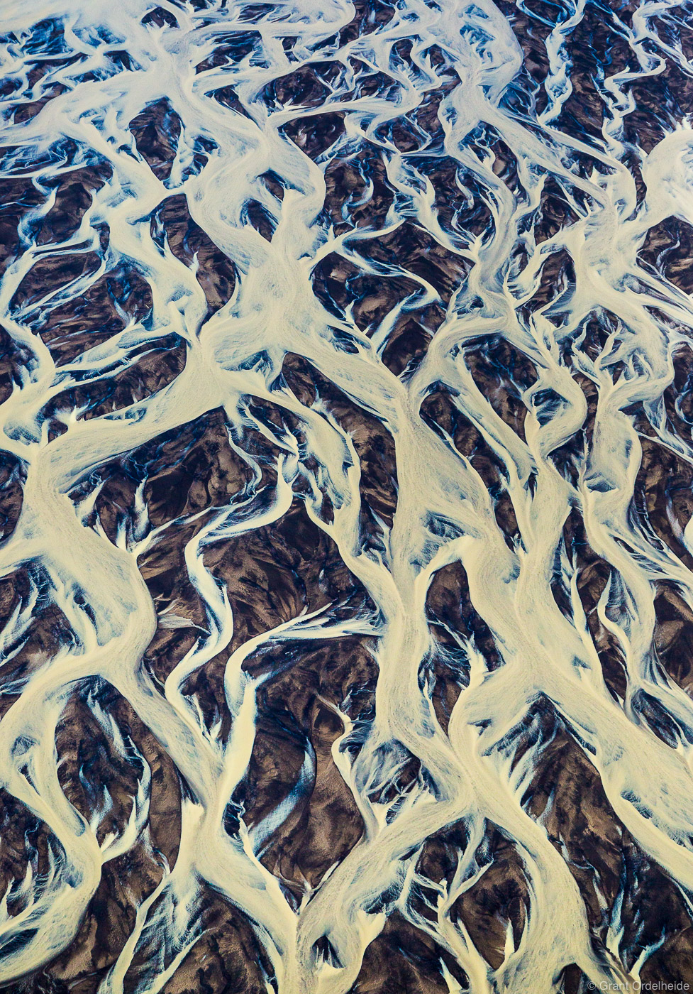 An aerial abstract of intertwining glacial rivers.