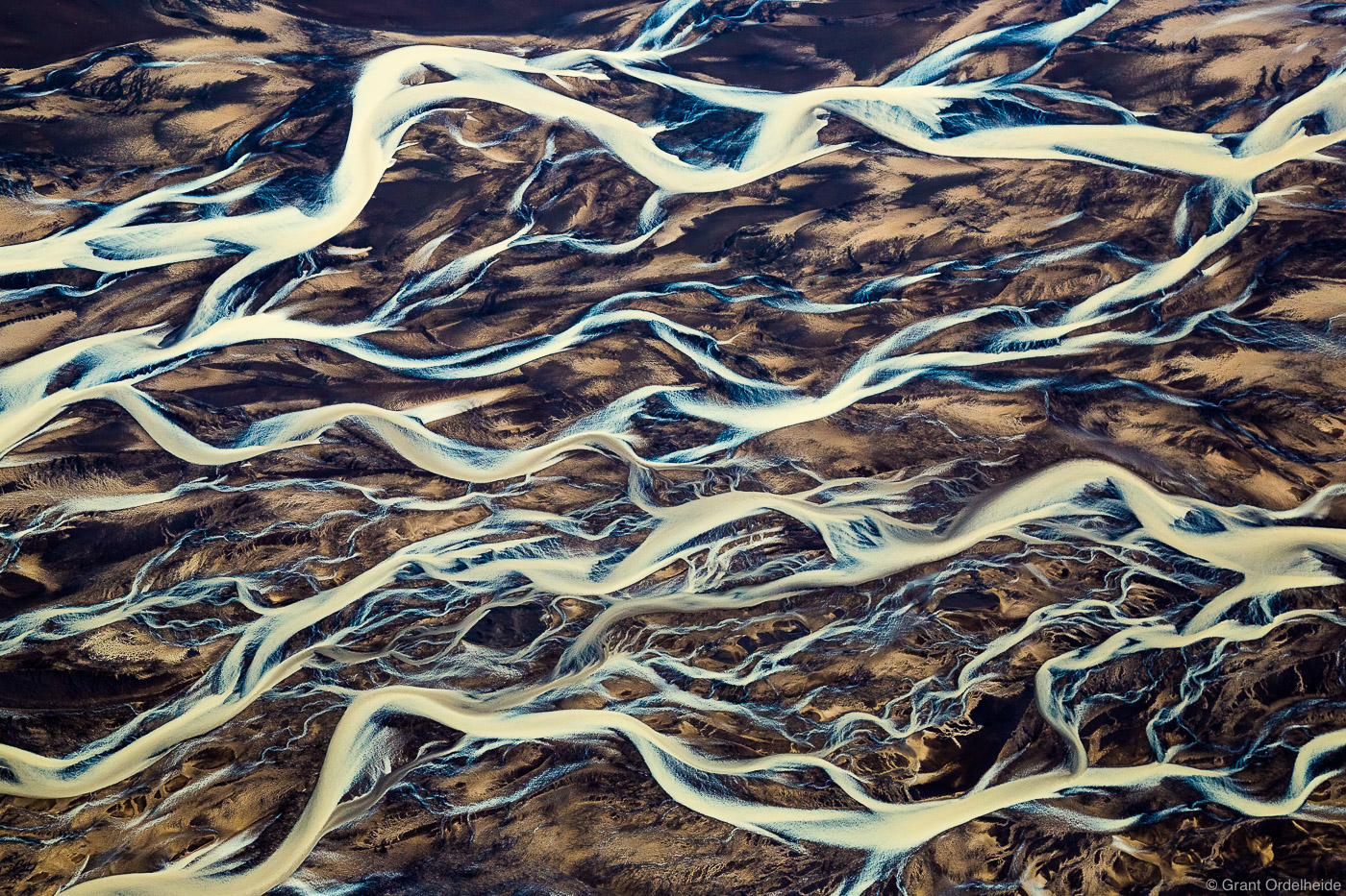 An aerial abstract of a glacial river delta.