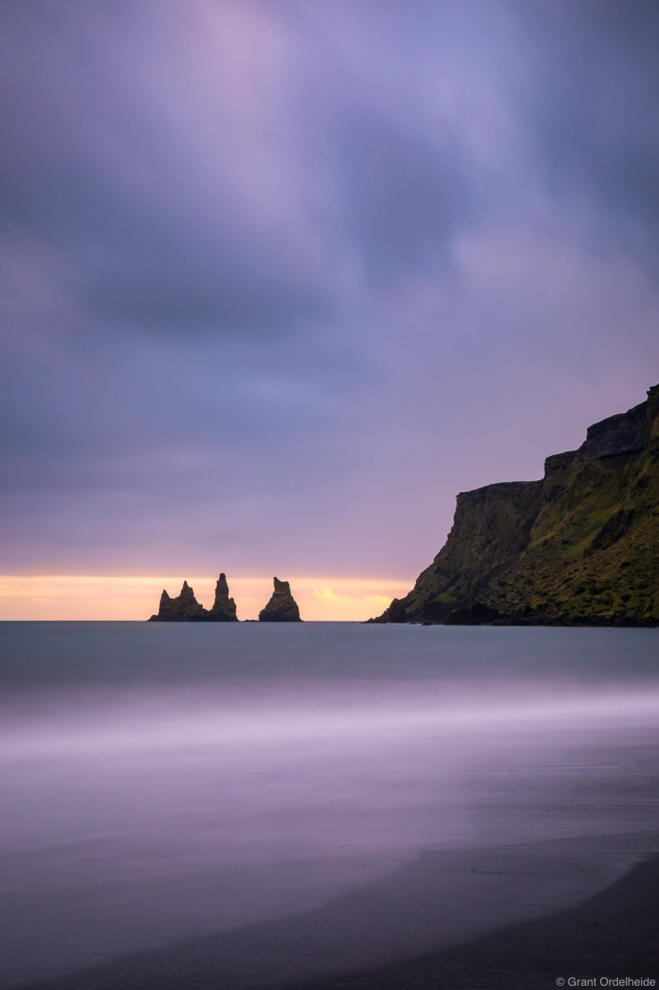 A stormy sunset from the beach along the small town of Vik on Iceland's southern coast.