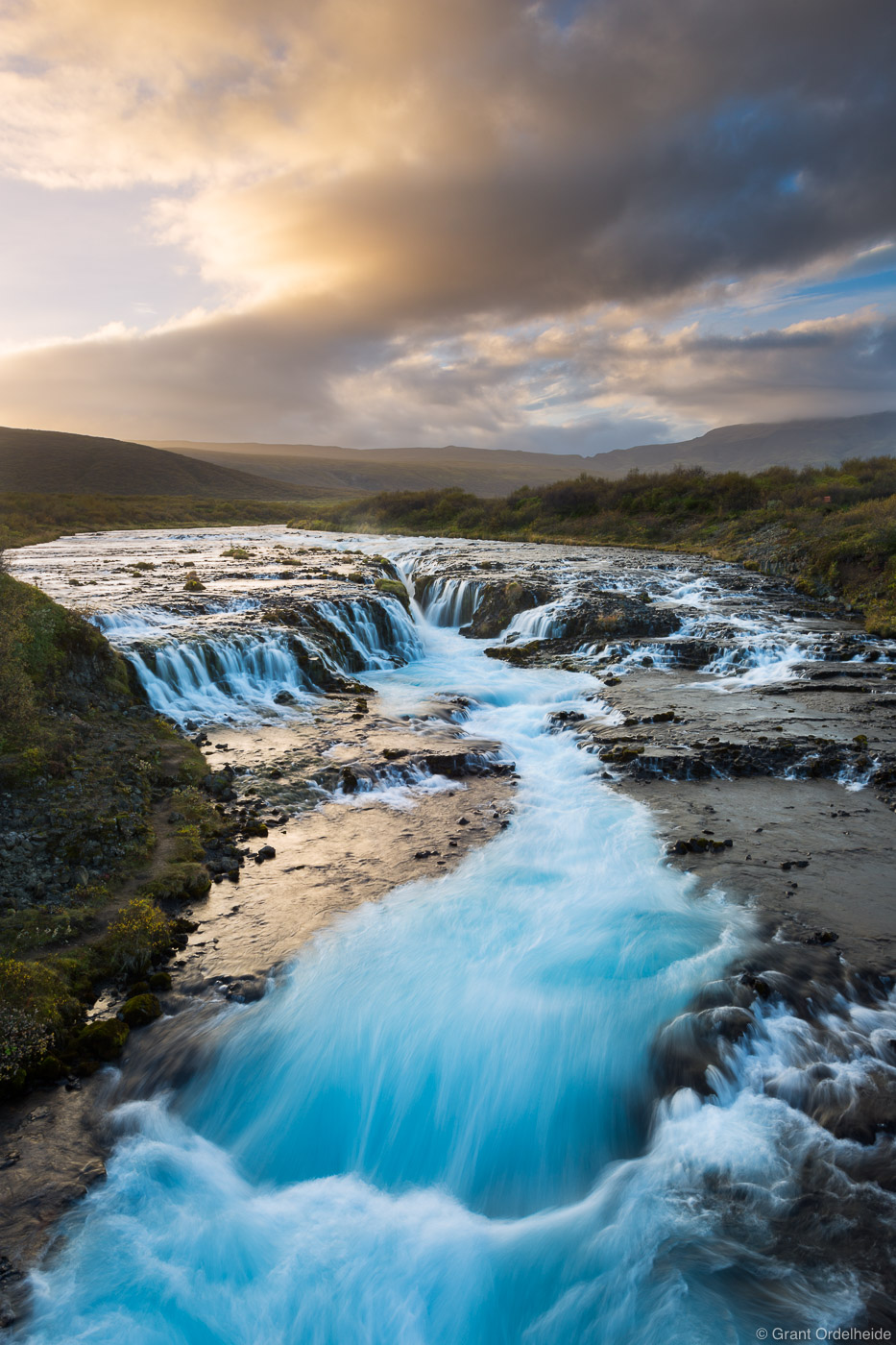Sunset over the beautiful waterfall known as Brúarfoss.