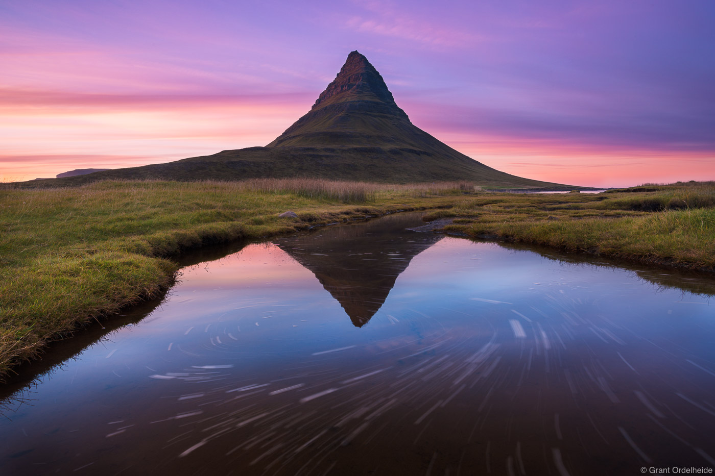 Kirkjufell mountain reflected in a small pond at sunset near&nbsp;Grundarfjörður, Iceland.