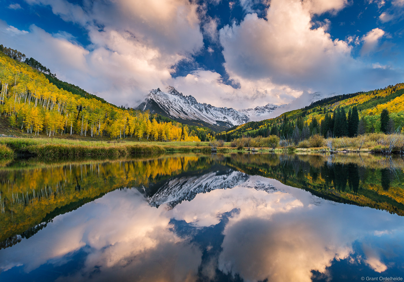 An autumn refelction of Mount Sneffels and stormy skies in a small beaver pond near Ridgway Colorado.