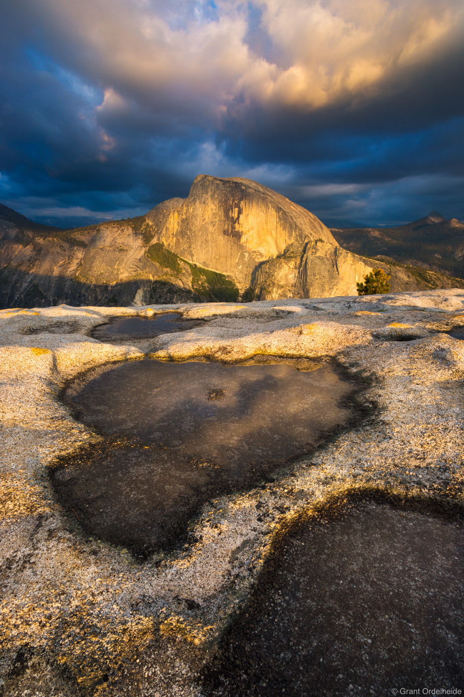 A dramatic sunset over Half Dome from across the valley on the summit of North Dome.