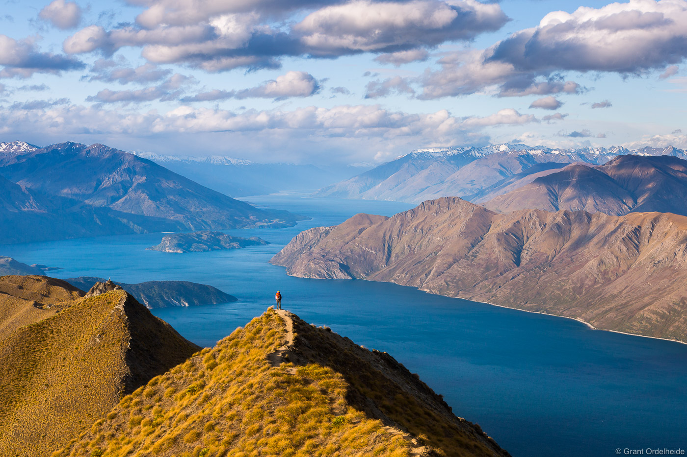 A hiker on the trail up Roy's Peak high above Lake Wanaka on New Zealand's South Island.