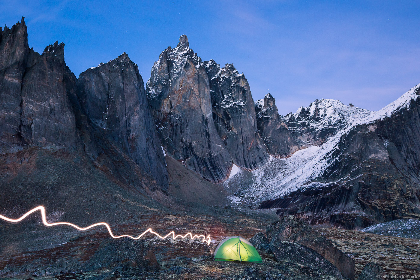 An illuminated tent&nbsp;below Mt. Monolith in Tombstone Territorial Park.