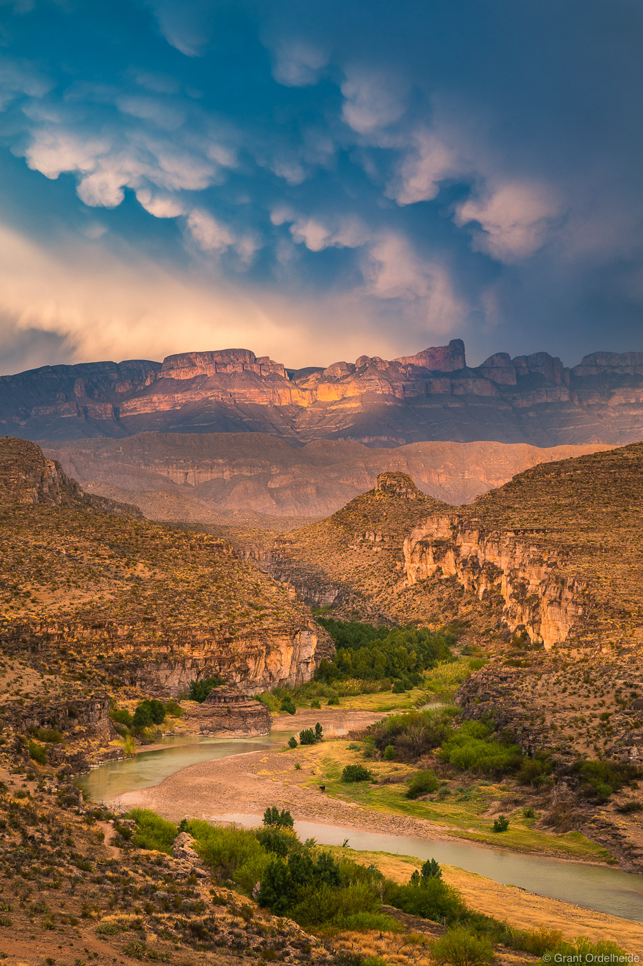 Storm light over the Rio Grande river and Sierra del Carmen Mountains viewed from Big Bend National Park.