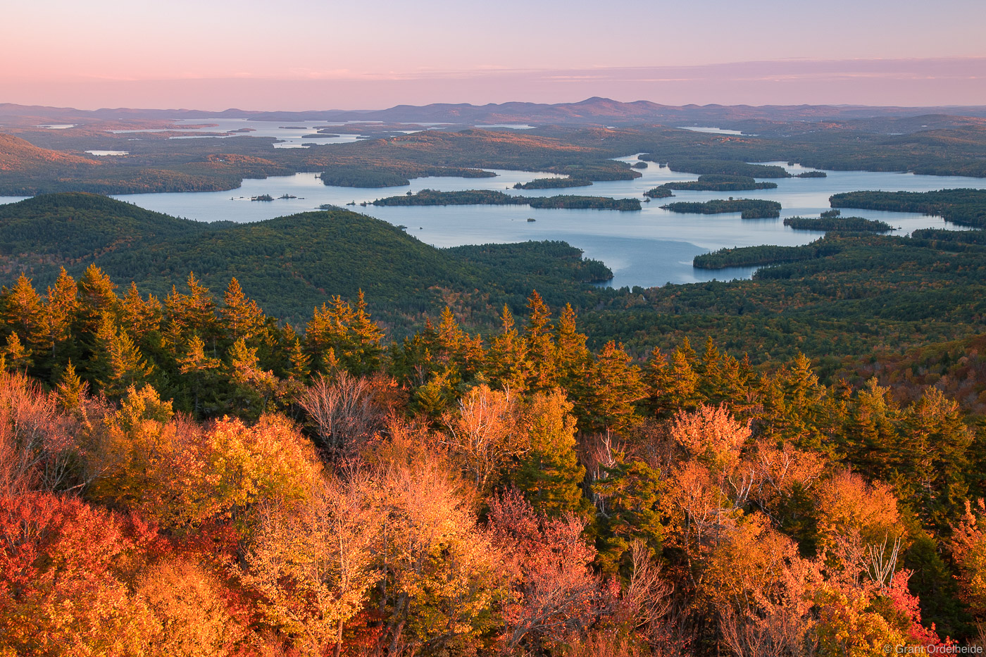 Autumn sunset over Squam Lake from the summit of Mount Morgan near Holderness, New Hampshire.