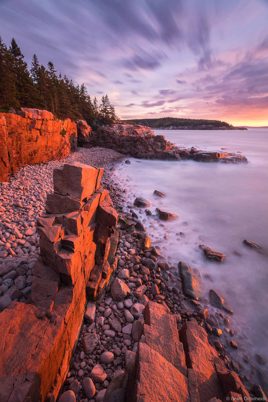 Sunrise over a rocky beach in Maine's Acadia National Park.