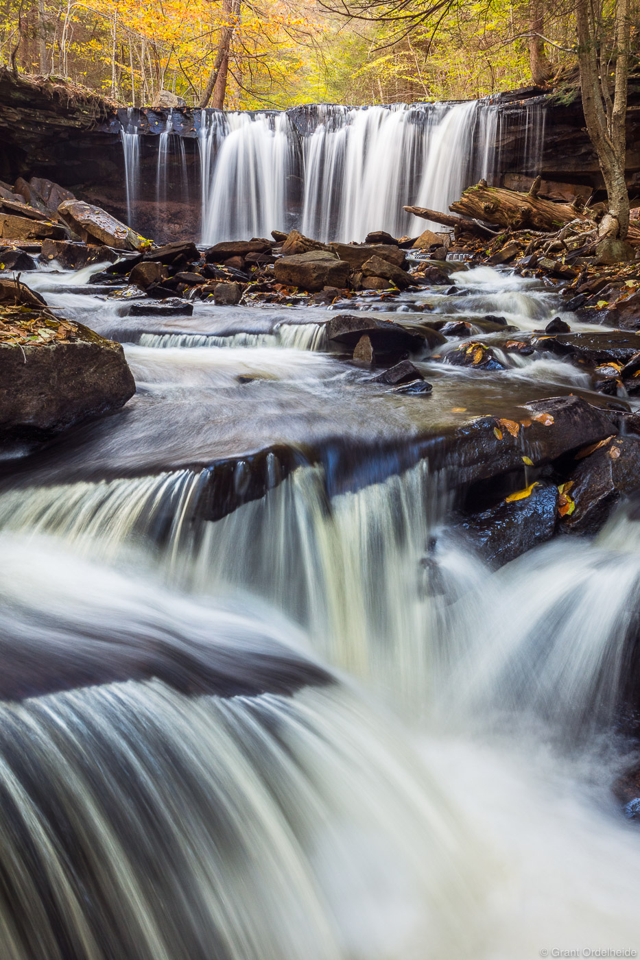 Fall foliage and cascading waterfalls in Pennsylvania's Ricketts Glen State Park.