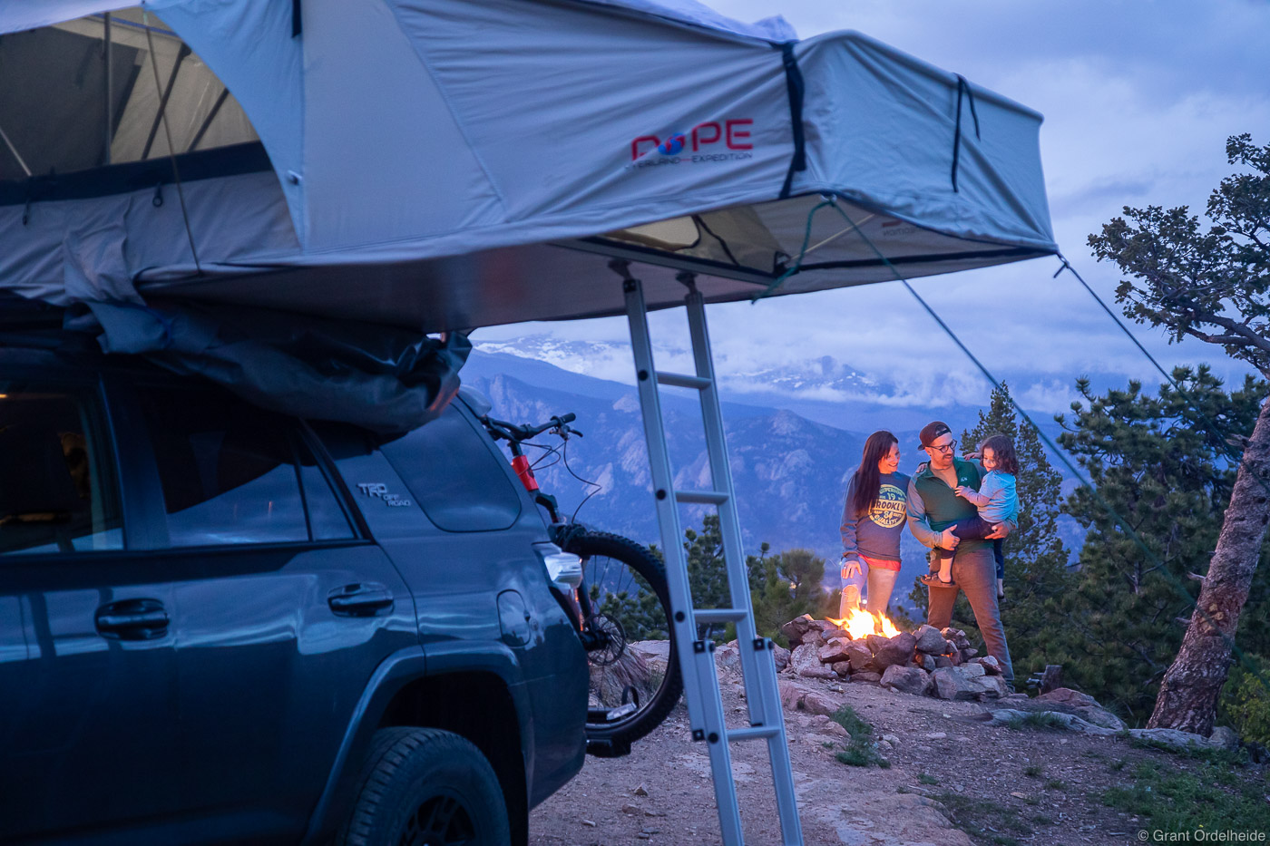 A family camping and enjoying a campfire on a cool Colorado evening.