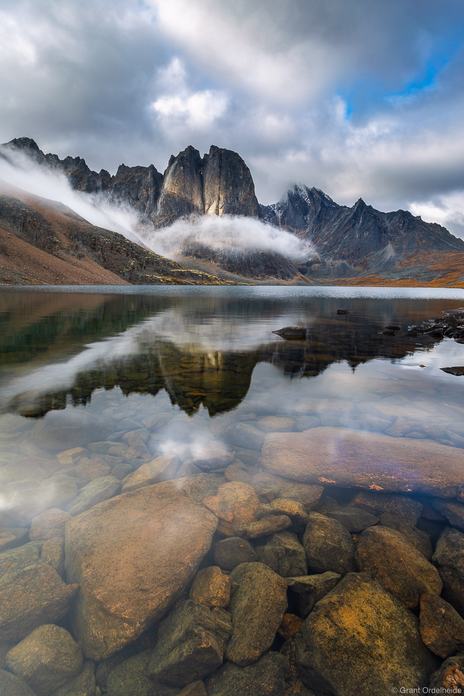 A serene autumn morning at Divide Lake in Canada's Tombstone Territorial Park.