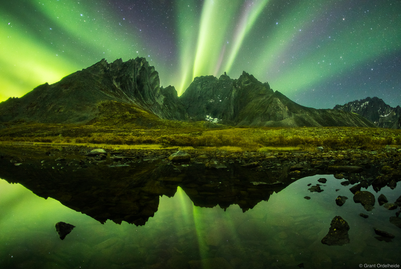 Northern lights over rugged peaks deep in the backcountry of Canada's Tombstone Territorial Park.