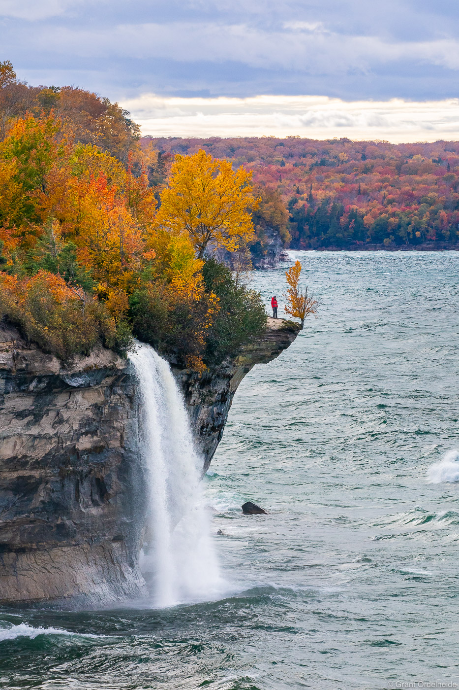 A hiker on the cliff above Lake Superior at Pictured Rocks National Lakeshore near Munising, Michigan.