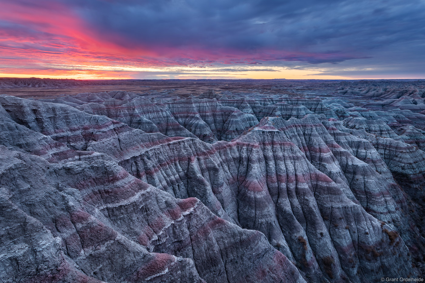 Sunrise over the arid landscape of South Dakota's Badlands National Park.