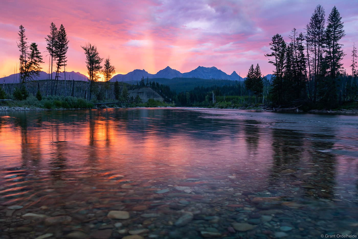 A stormy sunrise over the North Fork of the Flathead and the peaks of Glacier National Park.