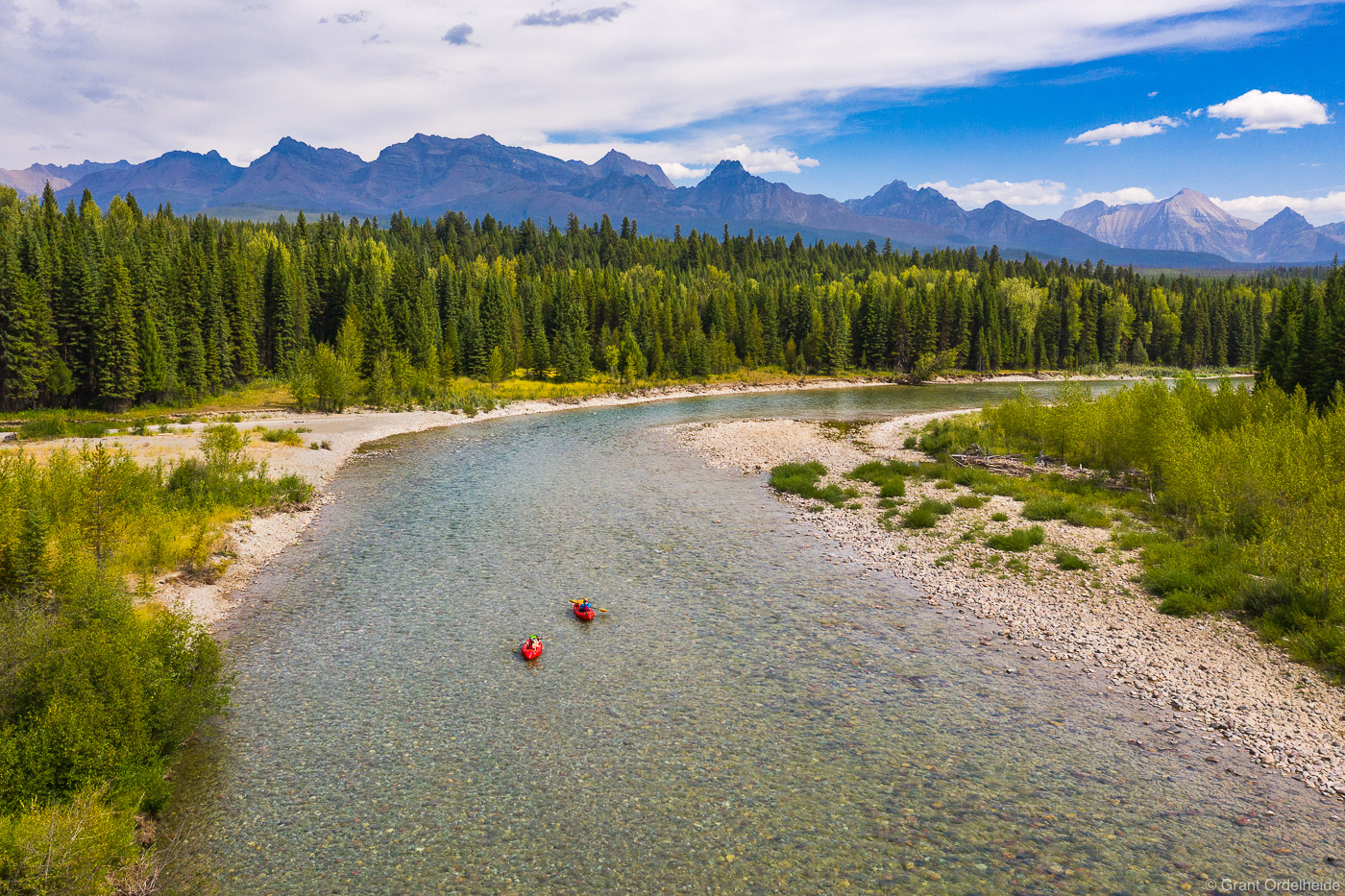 A couple of packrafters floating the North Fork of the Flathead river near Glacier National Park.