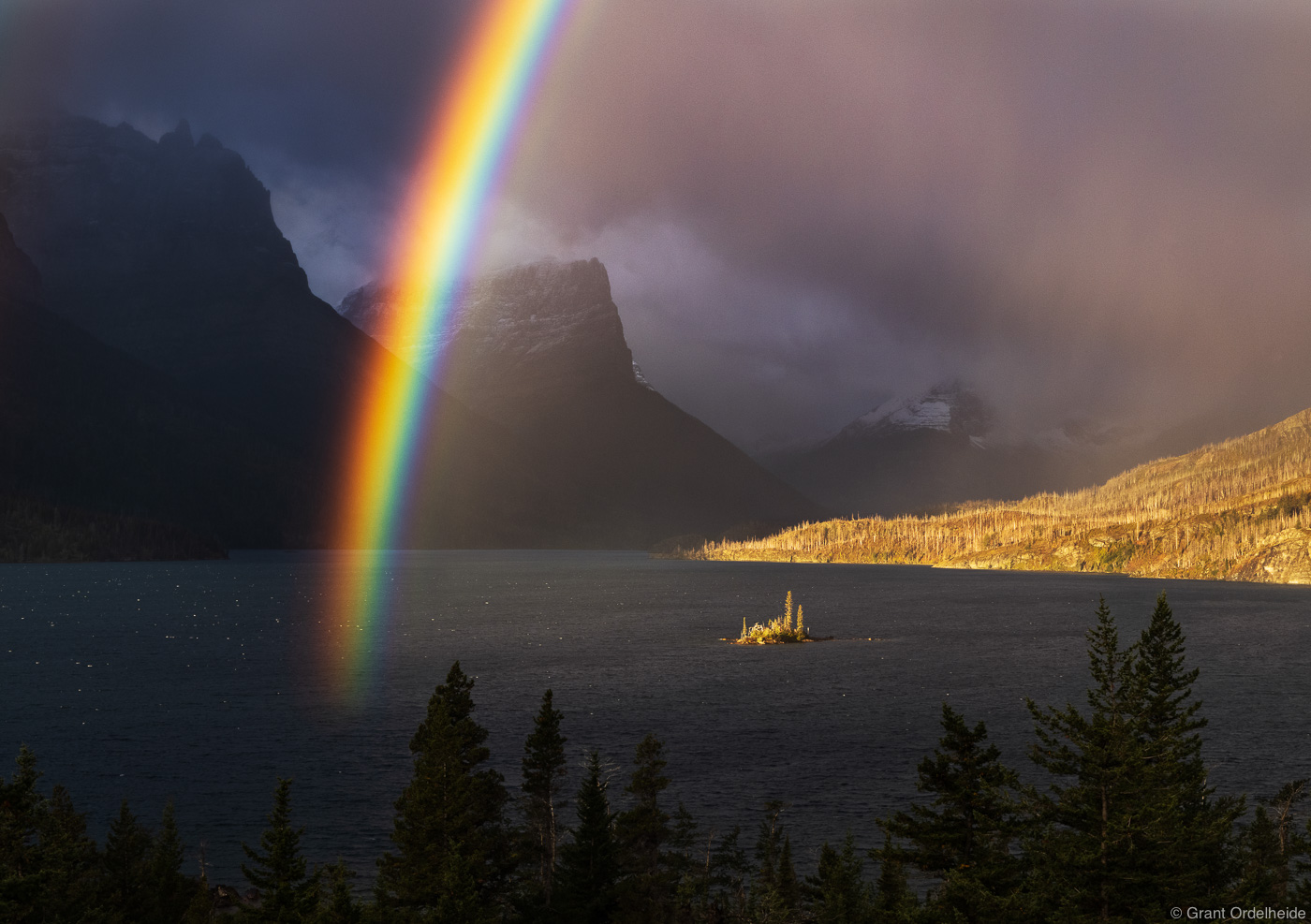 An incredibly vivid rainbow over Wild Goose Island and St. Mary Lake in Montana's Glacier National Park.