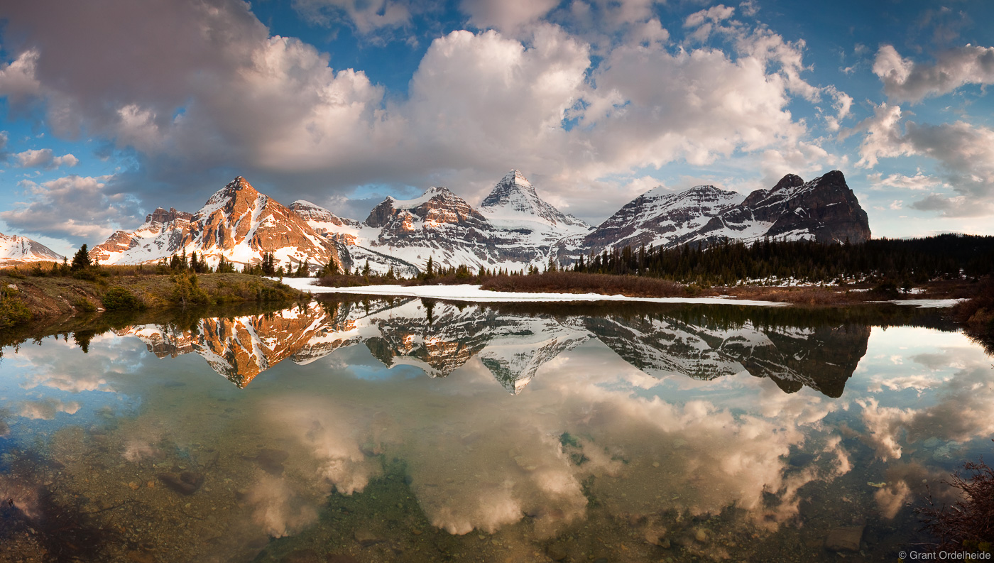 Mount Assiniboine reflected in a small alpine tarn in the Canadian Rockies.