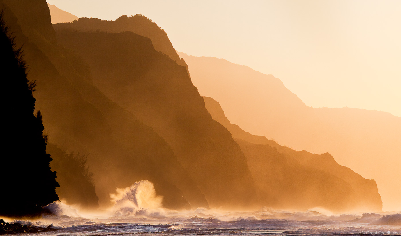 A wave crashes along the rugged Na Pali Coastline on Kauai's north shore.