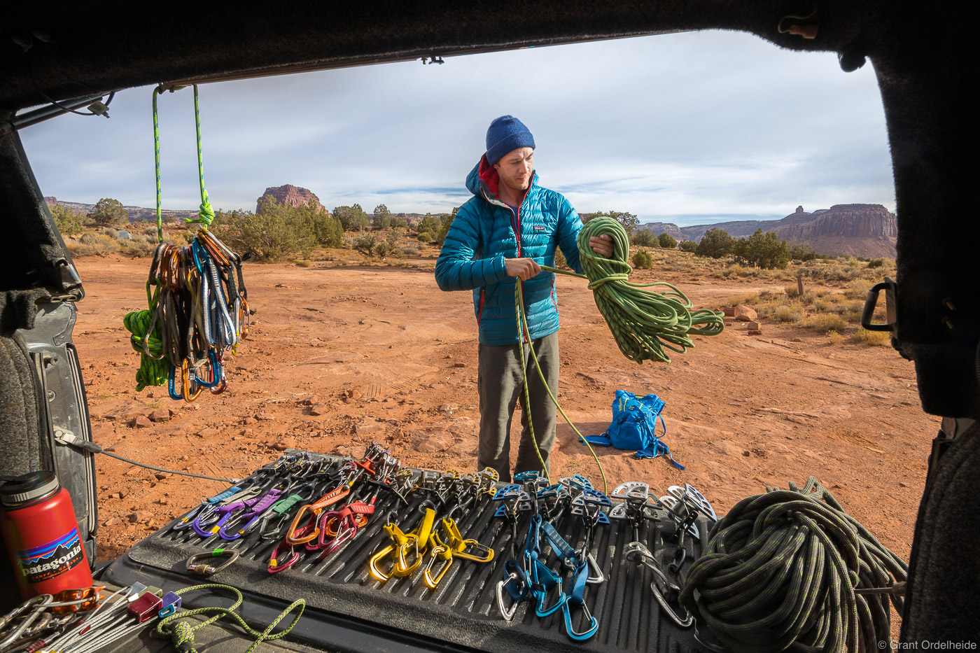 A climber organizing his climbing gear for a day of climbing in Utah's Indian Creek.